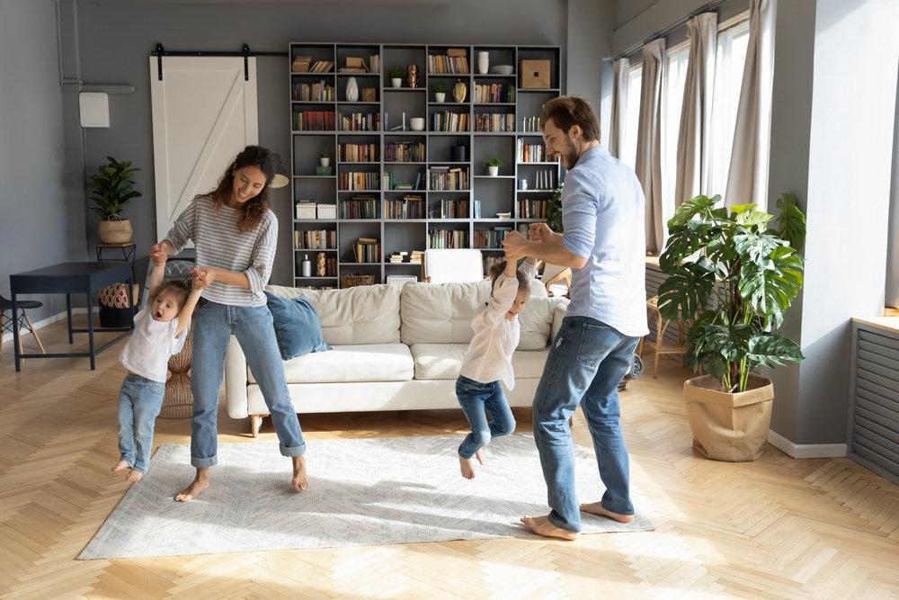 family at home breathing clean indoor air and having fun in the living room